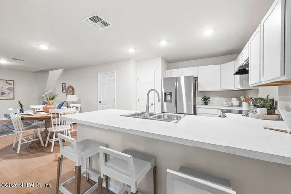 a kitchen with appliances cabinets and a sink