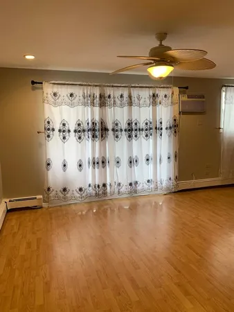 a view of a room with wooden floor