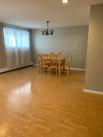 a view of a room with furniture and chandelier