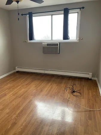 a view of a room with wooden floor and window