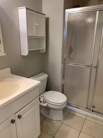 a bathroom with a toilet and a shower
