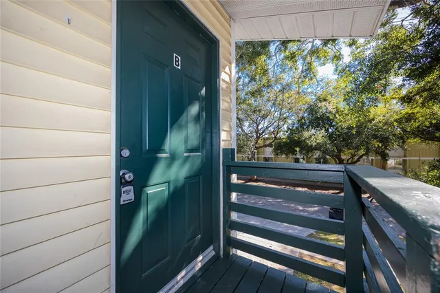 a view of a balcony with a floor to ceiling window and wooden floor