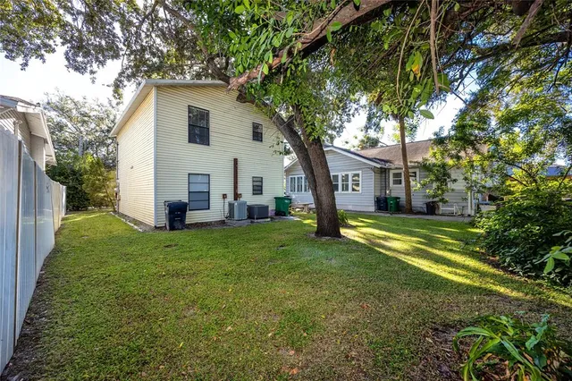 a view of a backyard with table and chairs