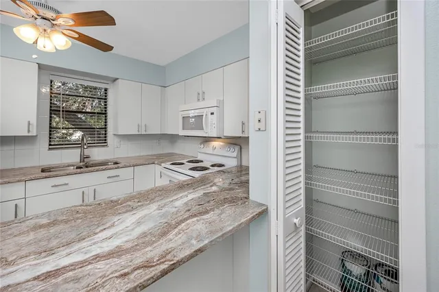 a kitchen with stainless steel appliances granite countertop a stove a refrigerator and a refrigerator