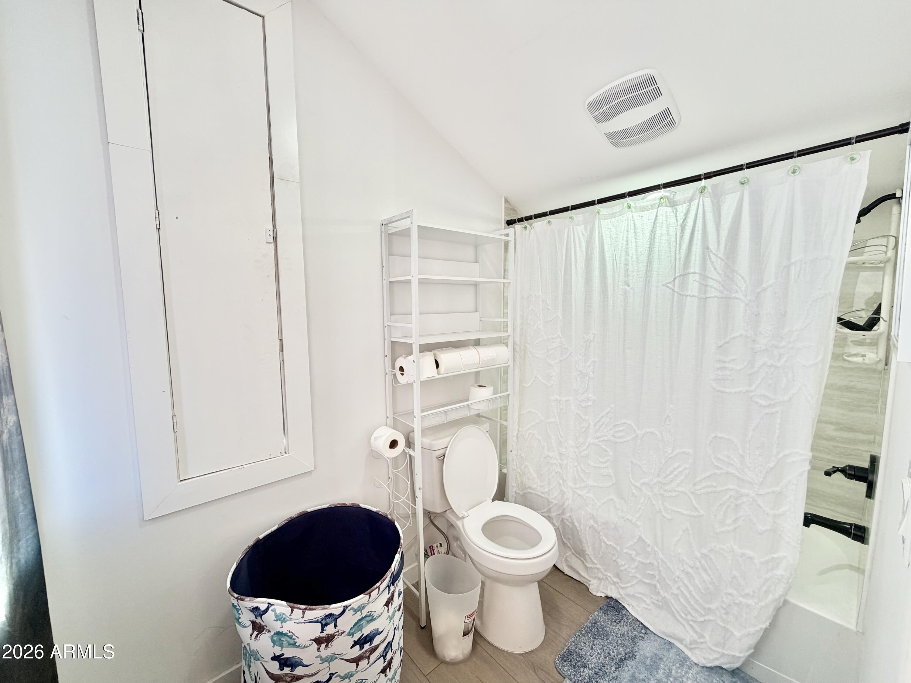 1925 Rock Castle Drive Prescott, AZ 86305 - Photo 21 of 25 a bathroom with a toilet and a shower curtain