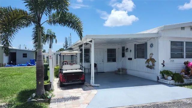 a front view of a house with a garden and patio
