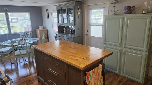 a kitchen with a table chairs and refrigerator