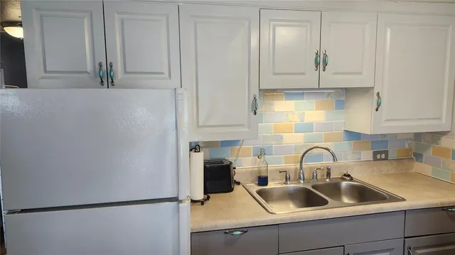 a kitchen with a sink and cabinets