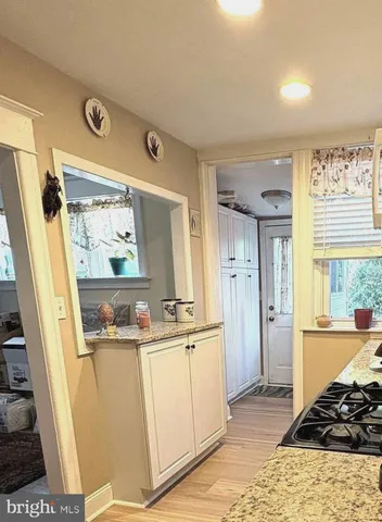 a front view of a house with a yard covered with snow