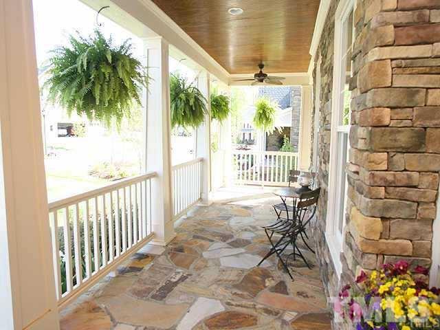 4214 Batiste Road Raleigh, NC 27613 - Photo 1 of 25 a view of a porch with a table and chairs and floor to ceiling window
