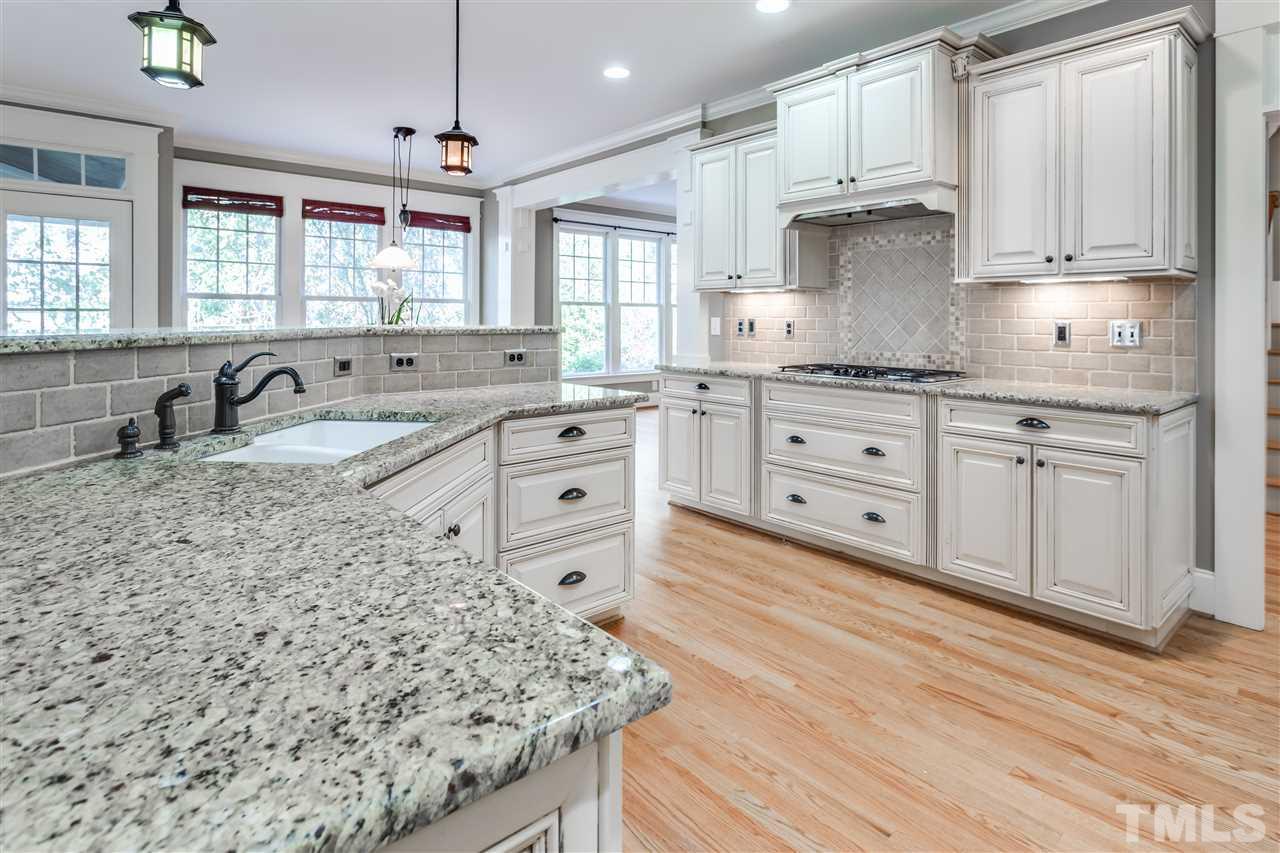 4214 Batiste Road Raleigh, NC 27613 - Photo 11 of 25 a kitchen with granite countertop a sink cabinets and wooden floor