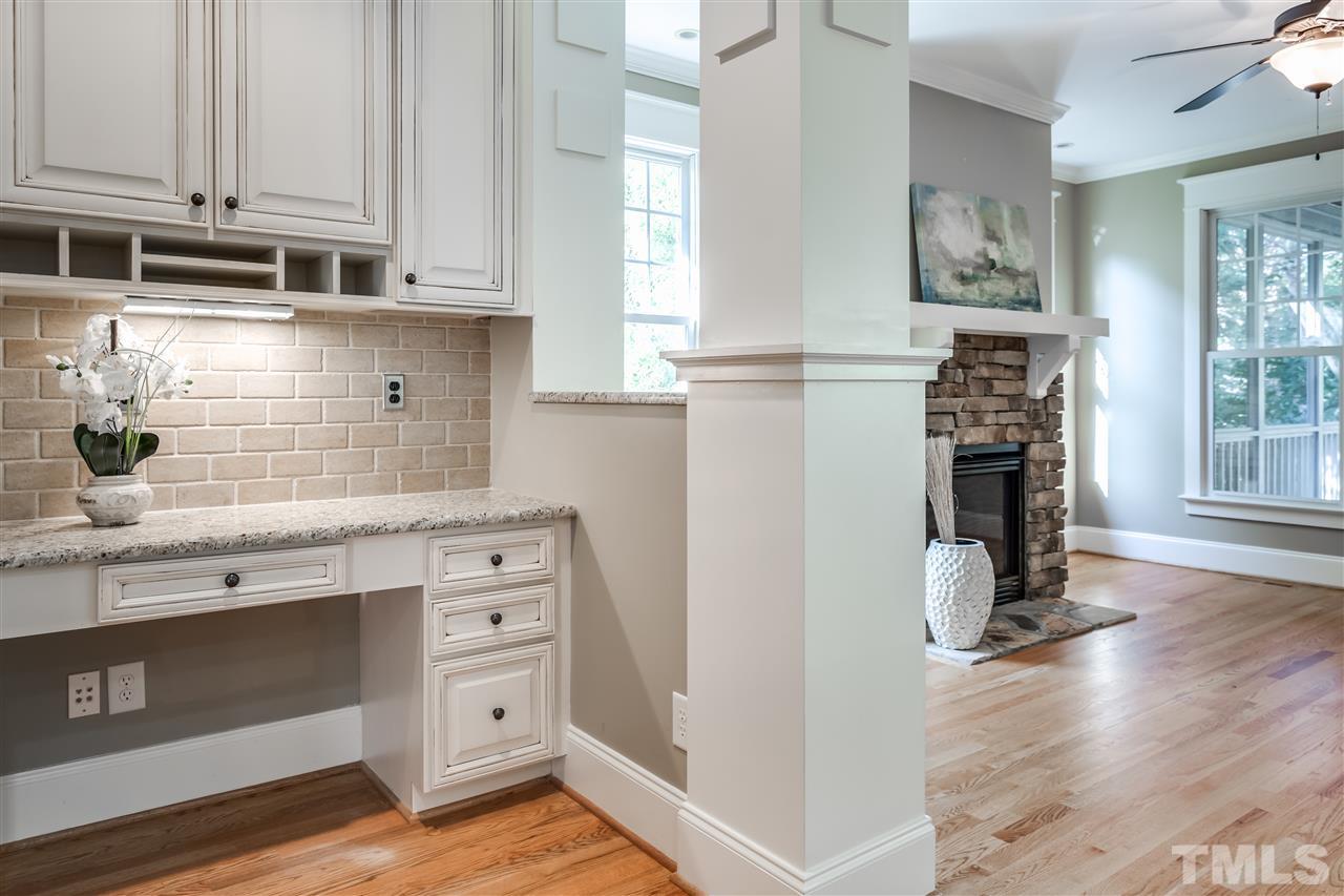 4214 Batiste Road Raleigh, NC 27613 - Photo 14 of 25 a kitchen with stainless steel appliances white cabinets and a wooden floor