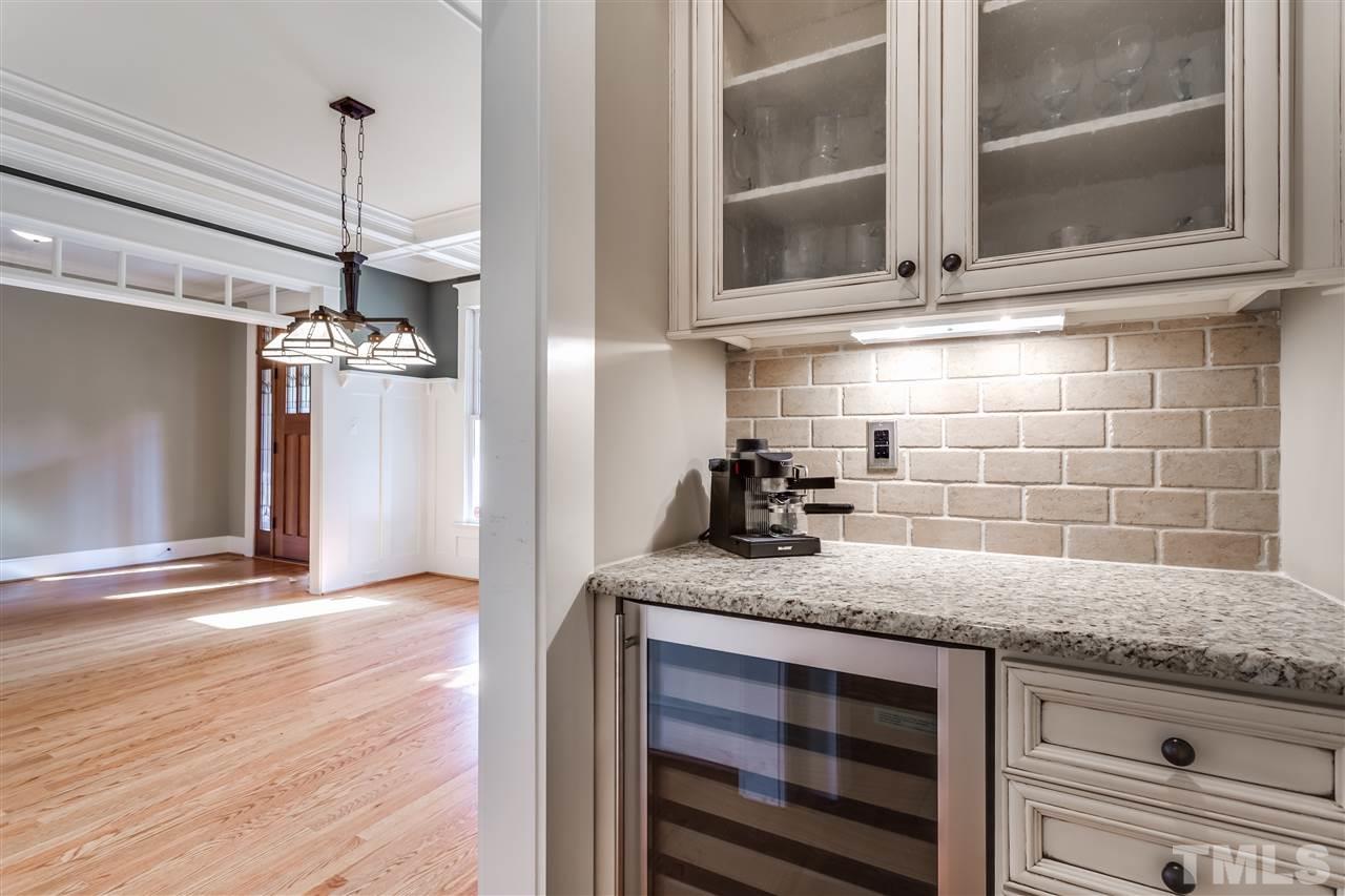 4214 Batiste Road Raleigh, NC 27613 - Photo 15 of 25 a kitchen with granite countertop a sink a counter space and cabinets