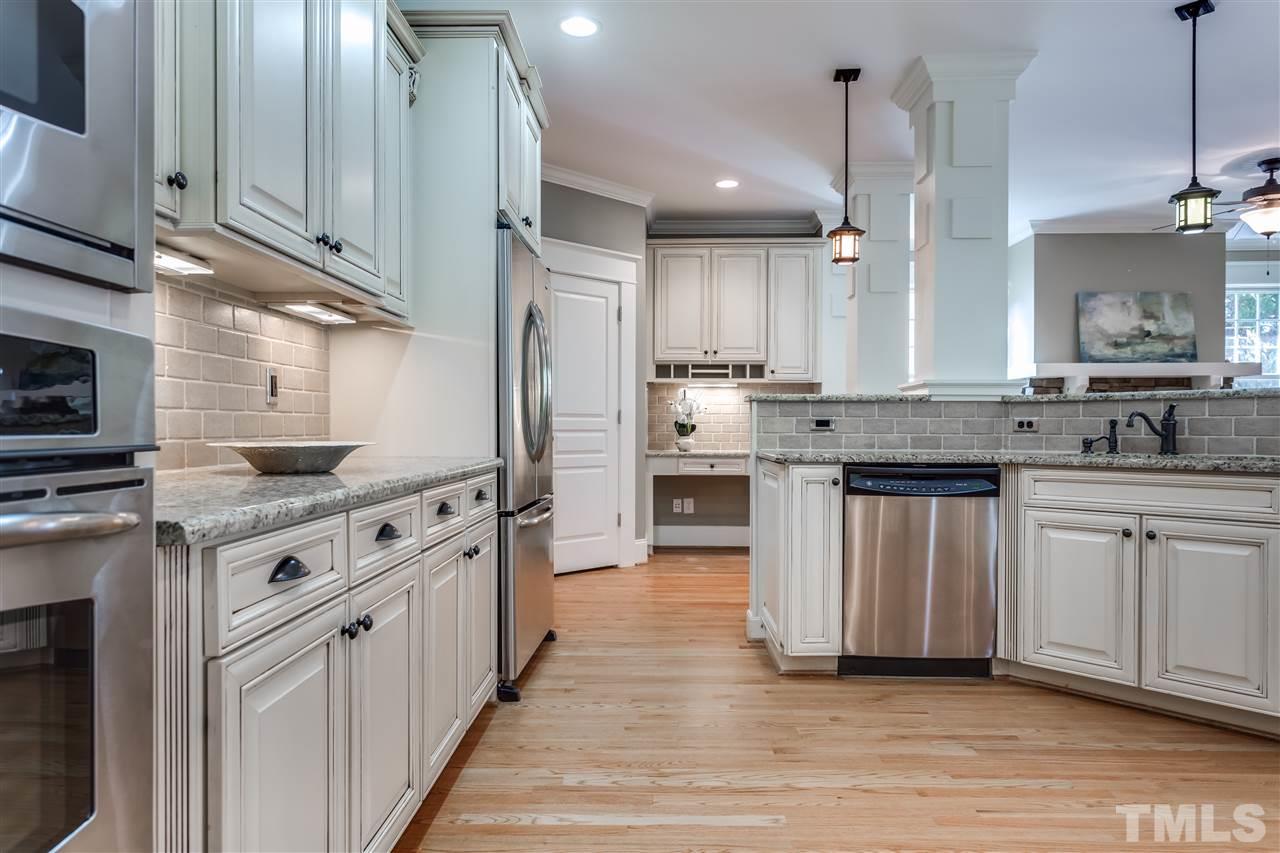 4214 Batiste Road Raleigh, NC 27613 - Photo 16 of 25 a kitchen with stainless steel appliances granite countertop a stove a sink and a refrigerator