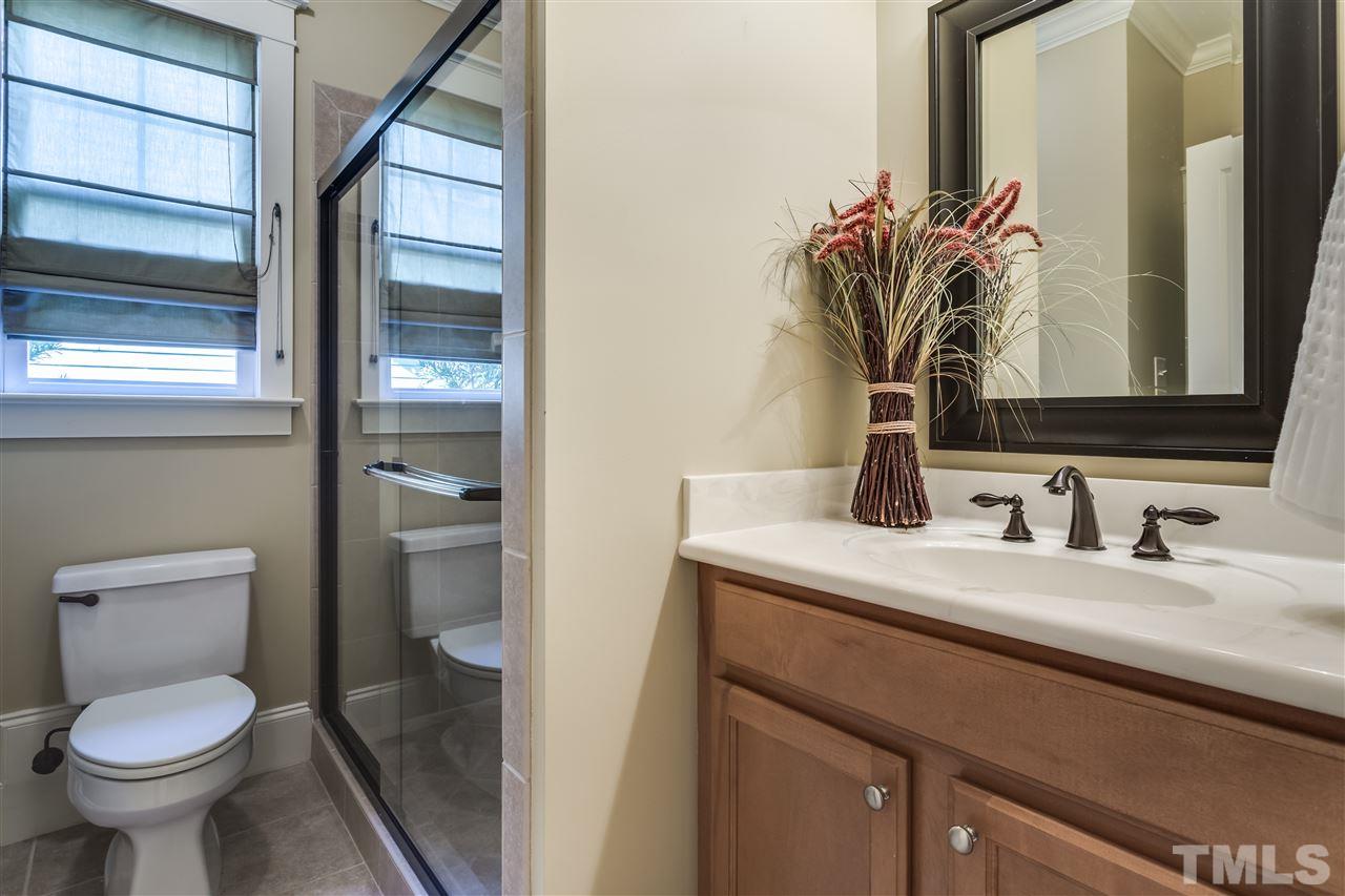 4214 Batiste Road Raleigh, NC 27613 - Photo 18 of 25 a bathroom with a toilet sink and mirror