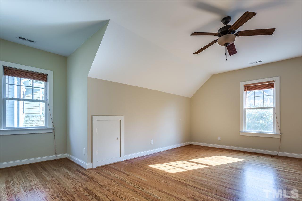 4214 Batiste Road Raleigh, NC 27613 - Photo 19 of 25 a view of empty room with wooden floor and fan