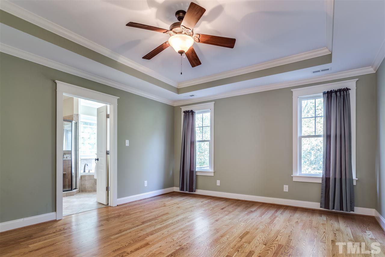 4214 Batiste Road Raleigh, NC 27613 - Photo 21 of 25 a view of an empty room with wooden floor and a window
