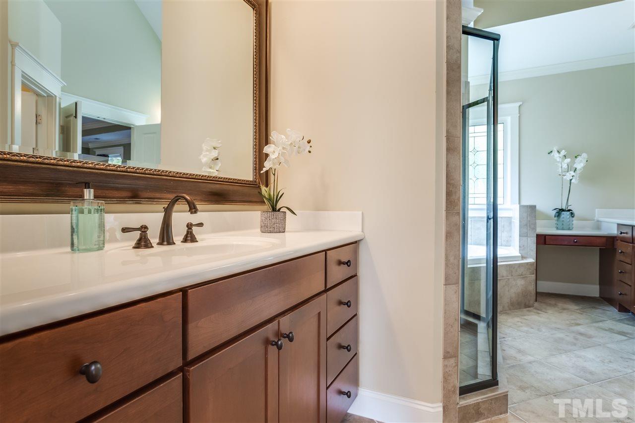 4214 Batiste Road Raleigh, NC 27613 - Photo 23 of 25 a bathroom with a sink and a mirror