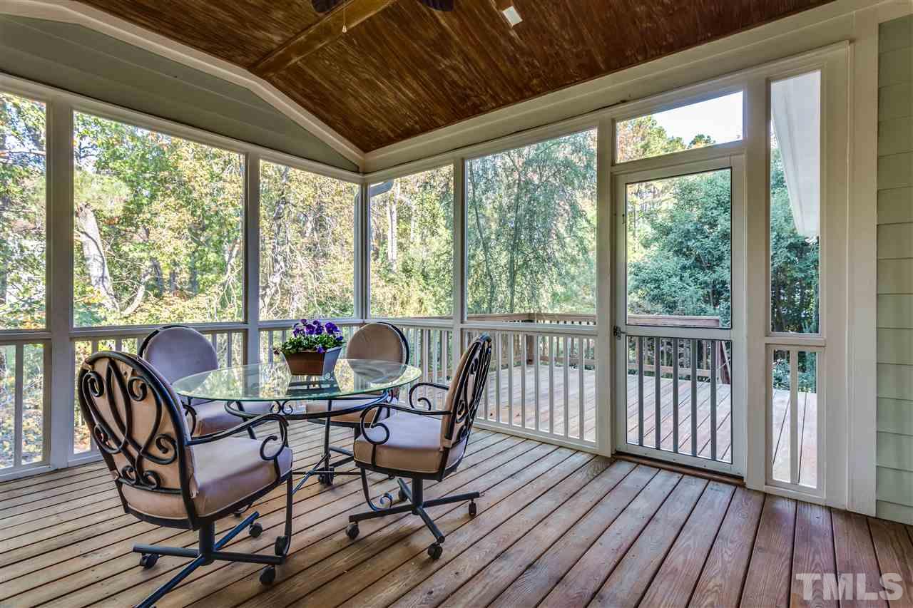 4214 Batiste Road Raleigh, NC 27613 - Photo 5 of 25 a dining room with furniture wooden floor and garden view