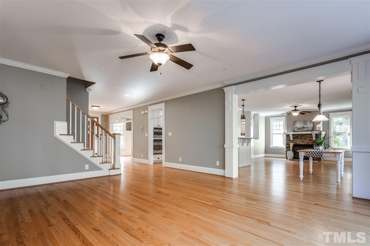 4214 Batiste Road Raleigh, NC 27613 - Photo 8 of 25 a view of empty room with wooden floor and windows