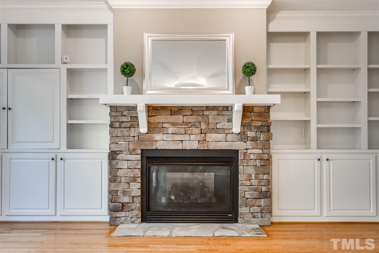 4214 Batiste Road Raleigh, NC 27613 - Photo 9 of 25 a view of living room with a fireplace and a wooden floor