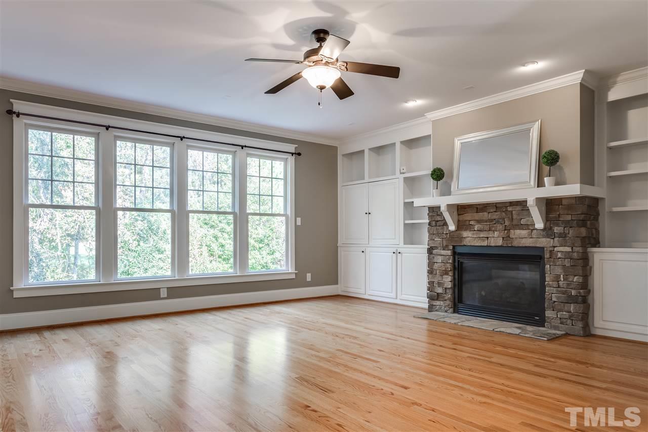 4214 Batiste Road Raleigh, NC 27613 - Photo 10 of 25 a view of an empty room with a fireplace and a window