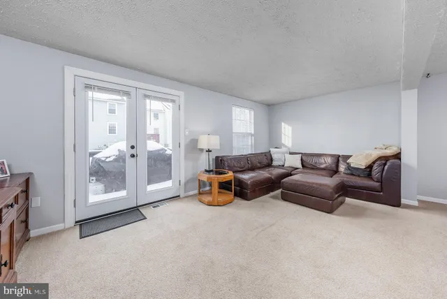a living room with furniture and a lamp