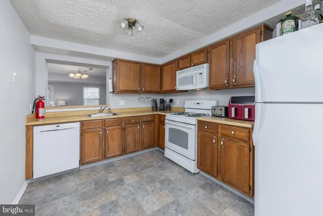a kitchen with sink a refrigerator and cabinets