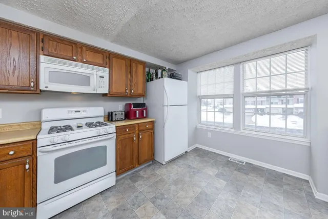 a kitchen with a stove a sink and a refrigerator