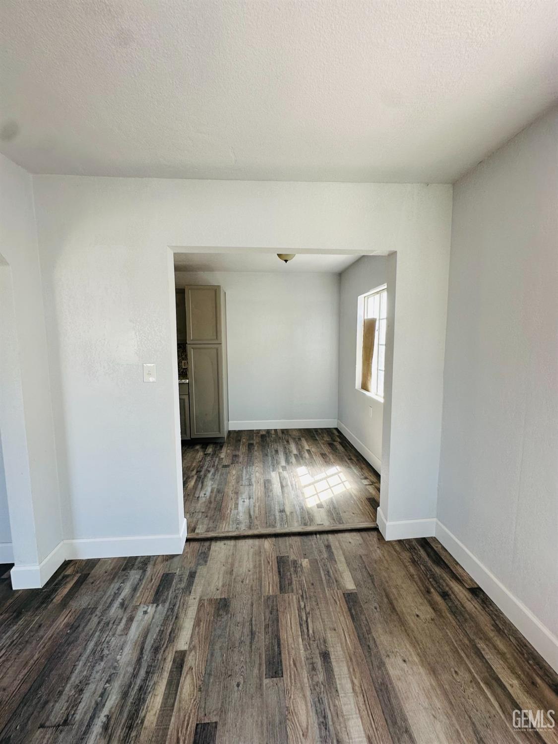 Undisclosed Address Delano, CA 93215 - Photo 14 of 20 an empty room with wooden floor and door