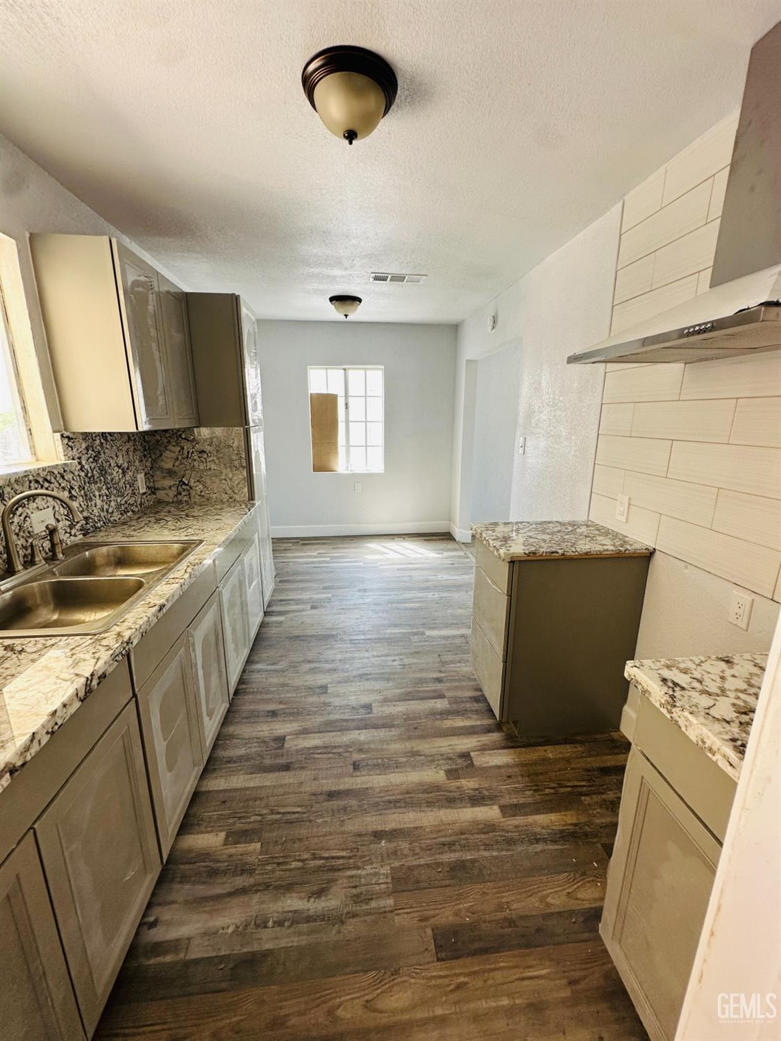 Undisclosed Address Delano, CA 93215 - Photo 16 of 20 a view of a kitchen counter space and wooden floor
