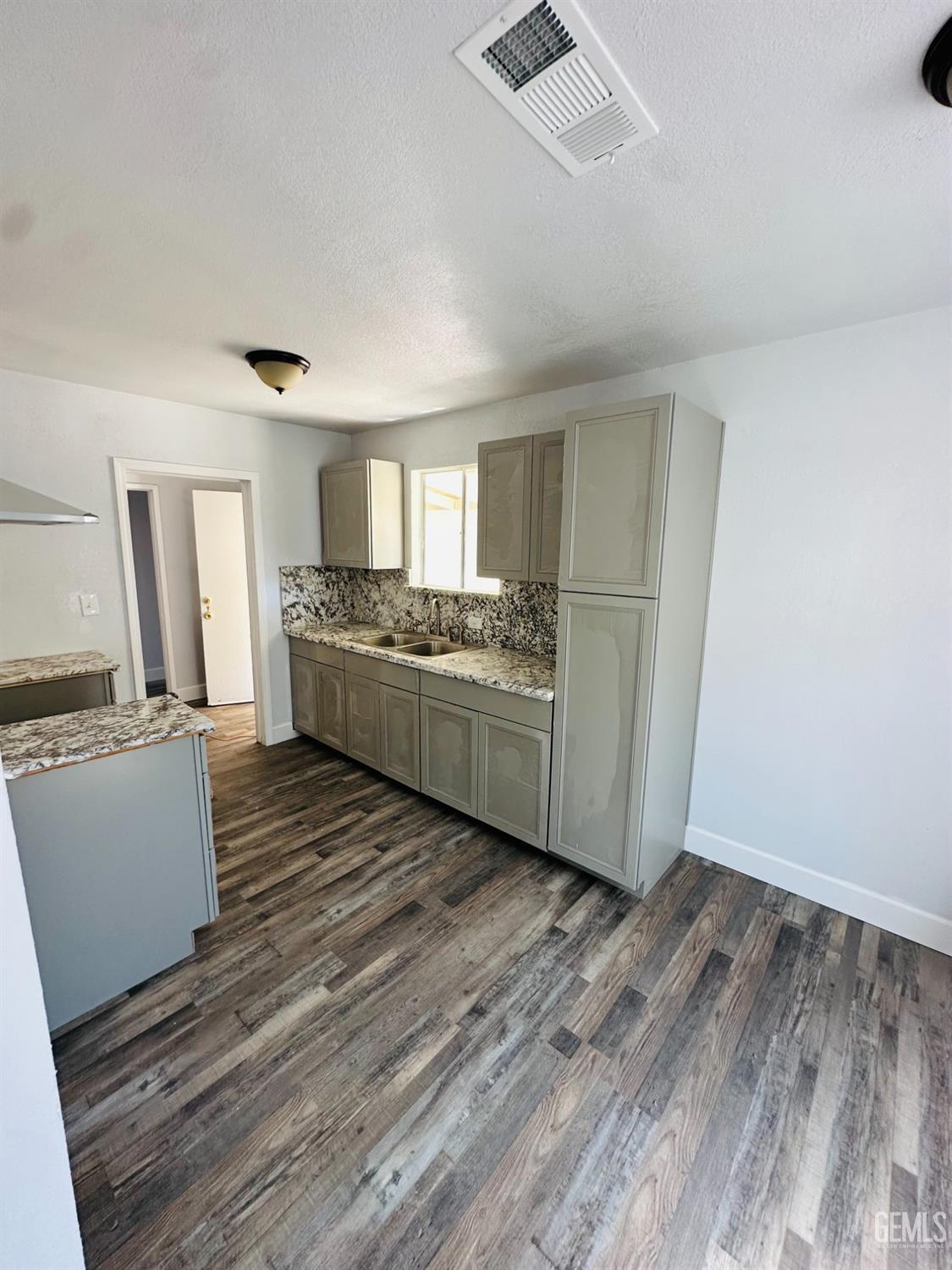 Undisclosed Address Delano, CA 93215 - Photo 17 of 20 a kitchen with stainless steel appliances granite countertop a stove and a refrigerator