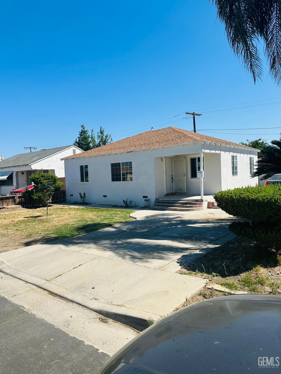 Undisclosed Address Delano, CA 93215 - Photo 2 of 20 a front view of a house with a yard