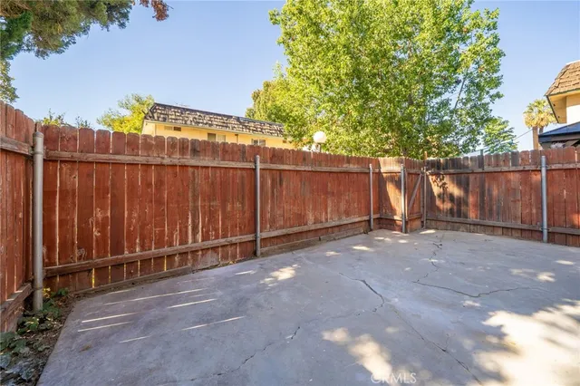 a view of a backyard with wooden fence