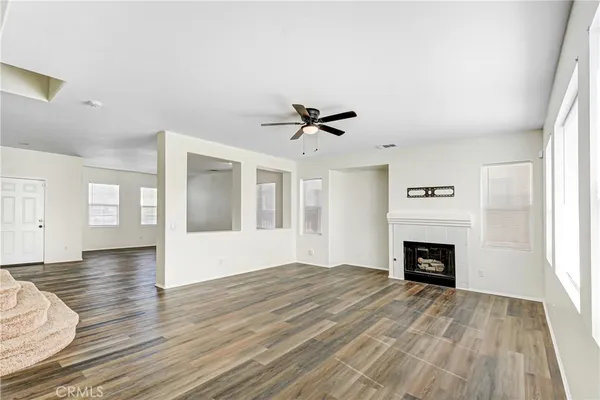 wooden floor in an empty room with a fireplace