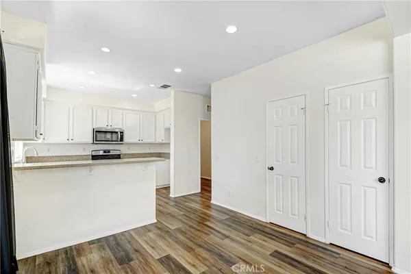 a kitchen with stainless steel appliances granite countertop a refrigerator and a stove top oven