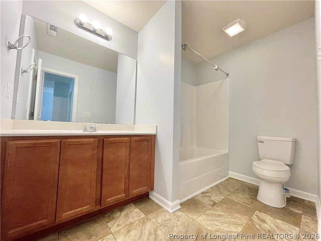 92 Hallow Oak Street Spring Lake, NC 28390 - Photo 7 of 11 a bathroom with a sink a toilet and shower