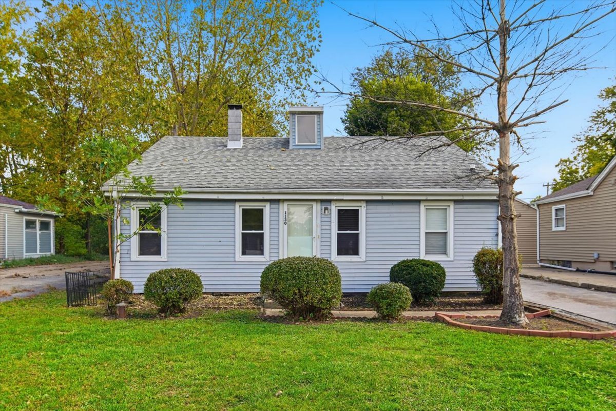 a front view of house with a garden