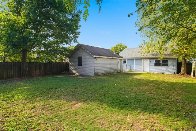 a view of a house with a backyard