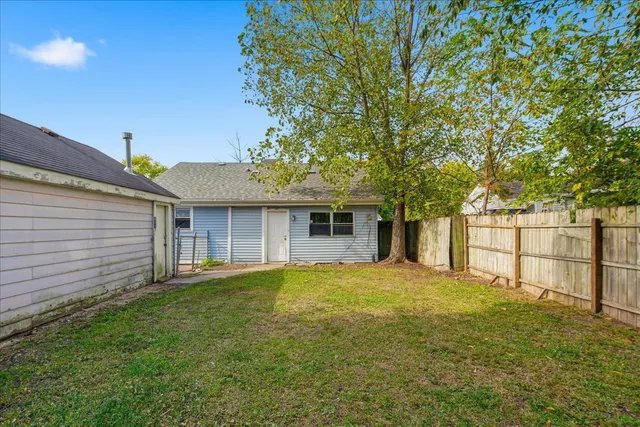 a view of a house with a yard and garage