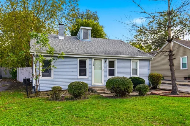 a view of a house with a yard porch and sitting area