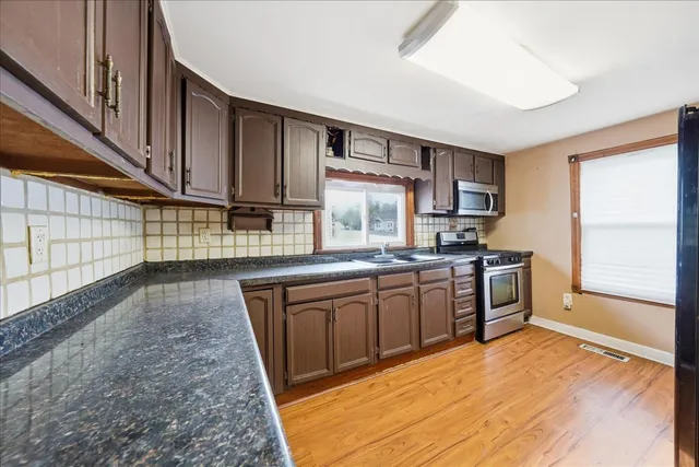 a kitchen with a sink stove and cabinets