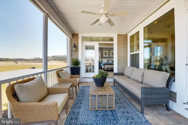 a living room with furniture and floor to ceiling windows