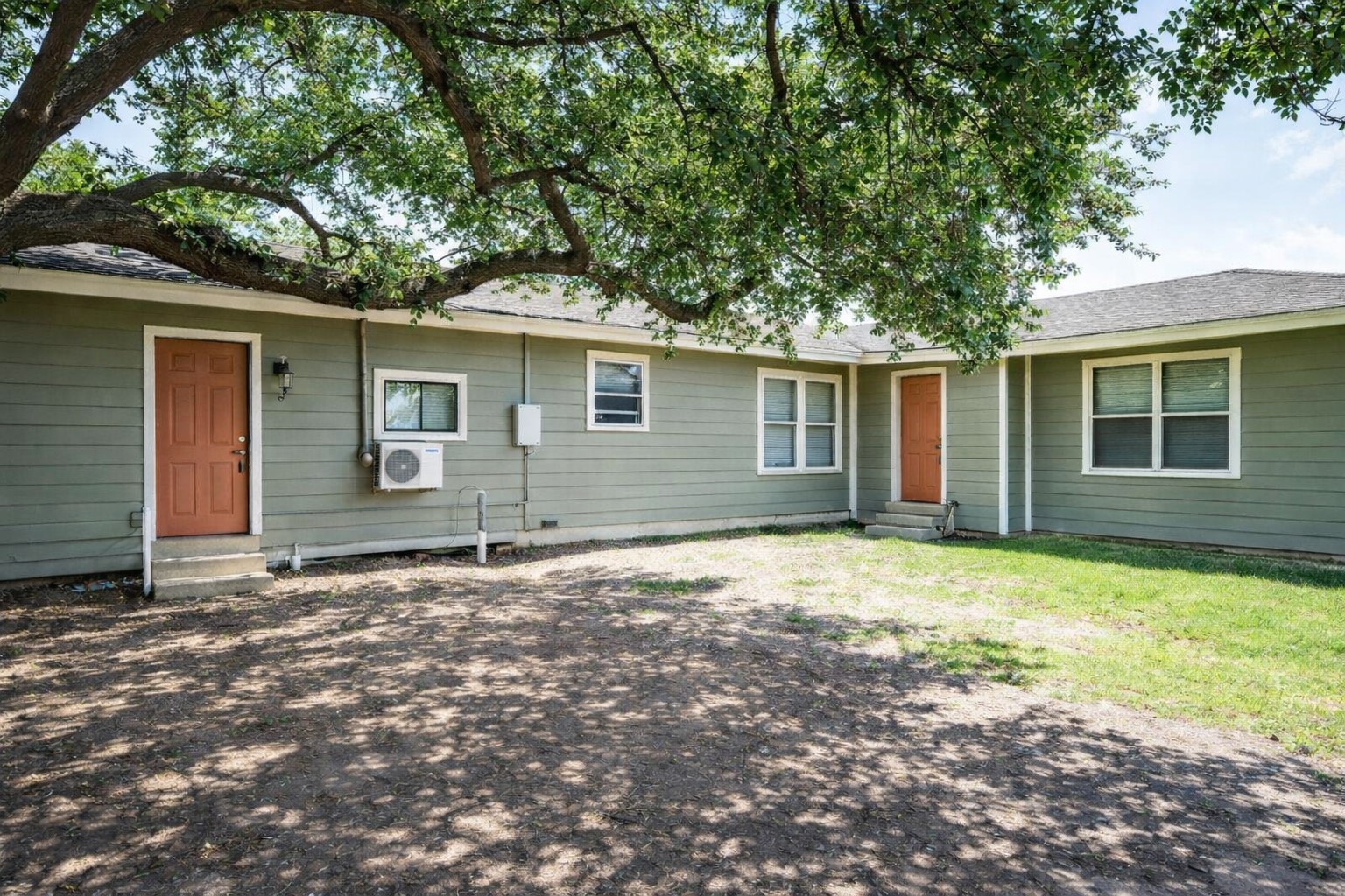 2727 Nelga Road, Unit B Wharton, TX 77488 - Photo 1 of 7 a house with trees in the background