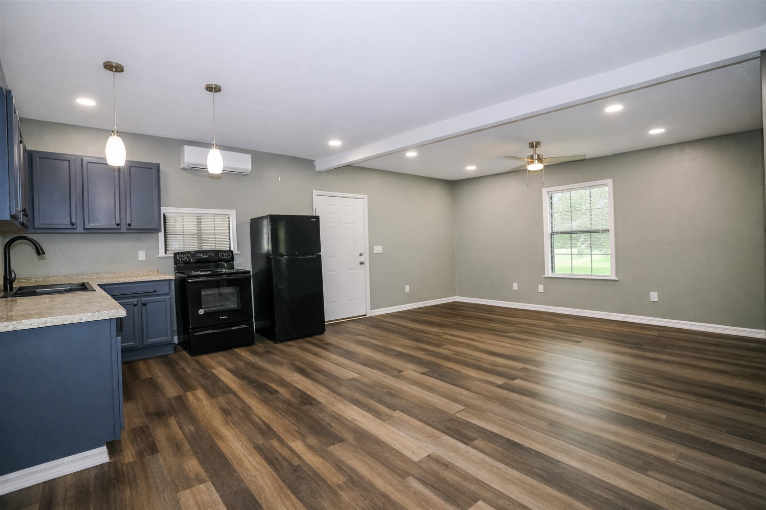 2727 Nelga Road, Unit B Wharton, TX 77488 - Photo 4 of 7 a kitchen with stainless steel appliances granite countertop a refrigerator and a sink