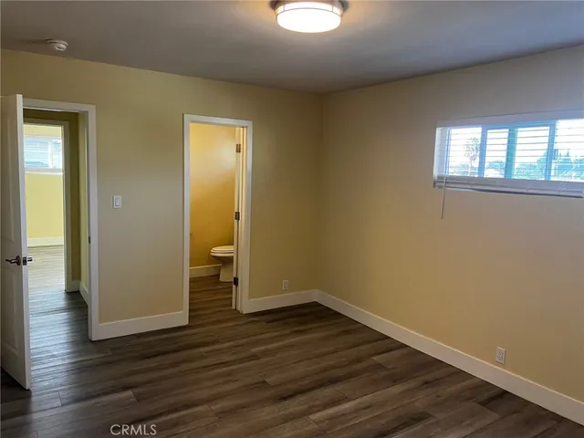 a view of a room with wooden floor and window