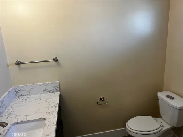 a white toilet sitting next to a shower