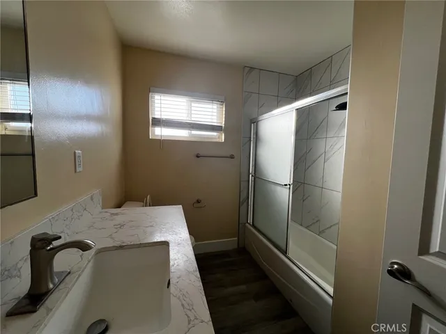 a bathroom with a shower and a sink