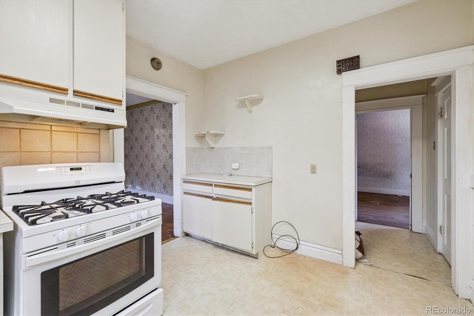 2510 Cherry Street Denver, CO 80207 - Photo 17 of 45 a kitchen with a stove and a refrigerator