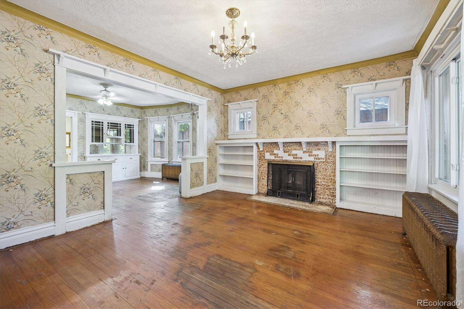 2510 Cherry Street Denver, CO 80207 - Photo 20 of 45 wooden floor fireplace and windows in an empty room